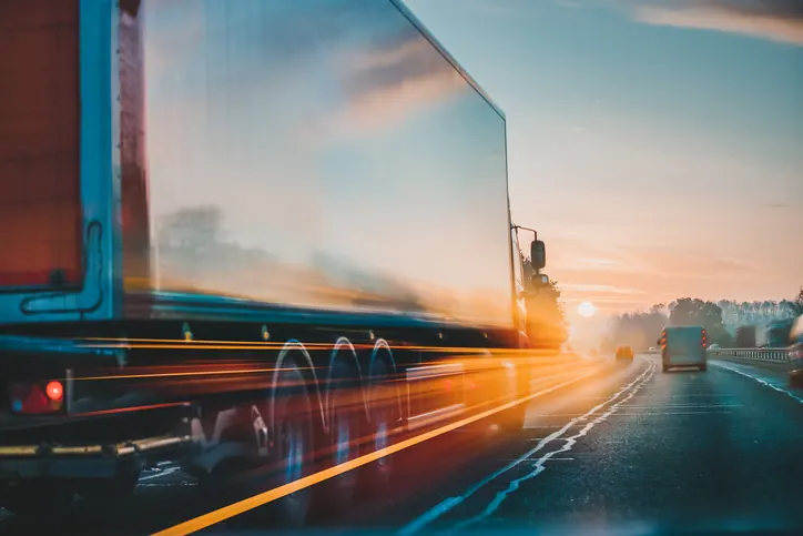 Fast turnaround and 24/7 road service — Bledsoe Truck & Trailer Repair, OKC Semi truck moving at highway speed at sunset — Bledsoe Truck & Trailer Repair offers fast turnaround and 24/7 road service so your truck spends less time off the road.