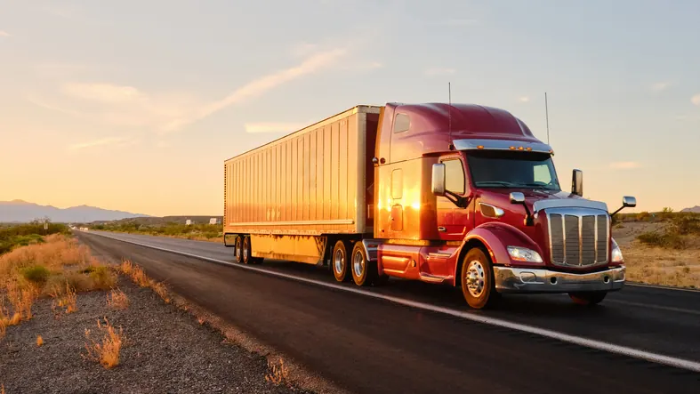 Bledsoe Truck & Trailer Repair — Oklahoma City's go-to shop for semi truck and trailer service Red Peterbilt semi truck on Oklahoma highway at sunset — Bledsoe Truck & Trailer Repair serves the I-44 corridor with heavy-duty truck repair in the Oklahoma City metro.